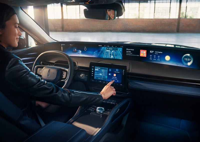 The driver of a 2024 Lincoln Nautilus® SUV interacts with the center touchscreen. | North Park Lincoln in San Antonio TX