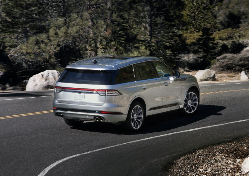 A 2023 Lincoln Aviator® Grand Touring model is shown being driven on a tight turn of a mountain road | North Park Lincoln in San Antonio TX