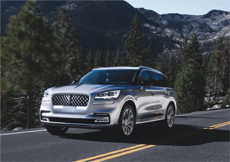 A 2023 Lincoln Aviator® Grand Touring SUV being driven on a winding road to demonstrate the capabilities of all-wheel drive | North Park Lincoln in San Antonio TX