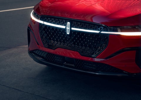 The available front LED light bar and center Lincoln Star logo glow at dusk. | North Park Lincoln in San Antonio TX