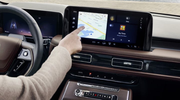 A person is tapping the center display touchscreen of a 2026 Lincoln Aviator® SUV. | North Park Lincoln in San Antonio TX