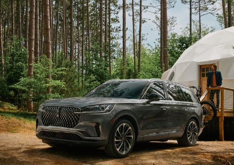 A 2027 Lincoln Aviator® is parked next to a high end glamping site. | North Park Lincoln in San Antonio TX
