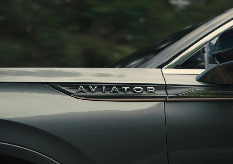 The driver’s side door and fender badging of a gray 2027 Lincoln Aviator® SUV are showcased. | North Park Lincoln in San Antonio TX