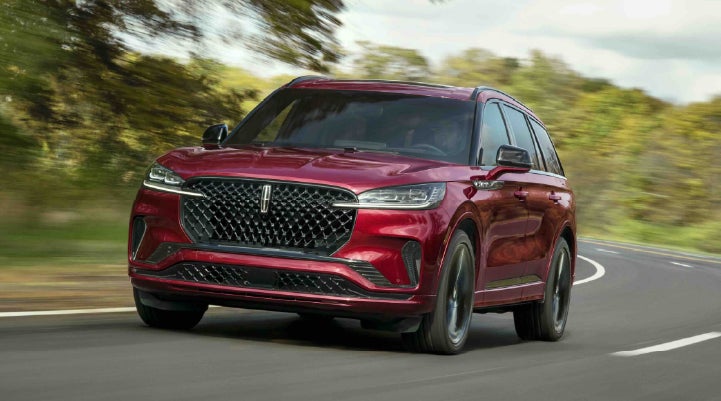 A 2027 Lincoln Aviator® SUV is being driven on a country road | North Park Lincoln in San Antonio TX