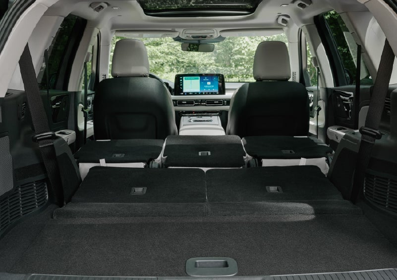 A rear to front view of the interior of a 2027 Lincoln Aviator® Black Label™ SUV shows the third and second rows folded flat | North Park Lincoln in San Antonio TX