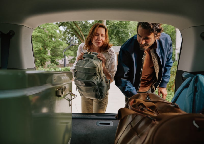 A couple loads luggage into the rear of a 2027 Lincoln Aviator® Black Label™ SUV..e 202 | North Park Lincoln in San Antonio TX