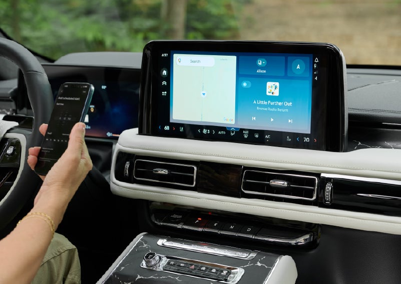 A person pairs thier phone with the center touchscreen of a 2027 Lincoln Aviator® Black Label™ SUV | North Park Lincoln in San Antonio TX